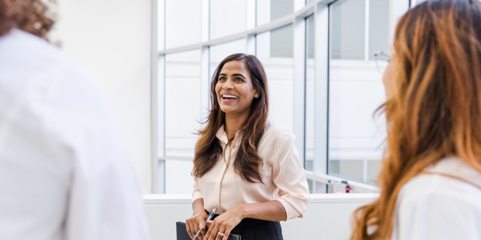 person cheerfully talking to colleagues